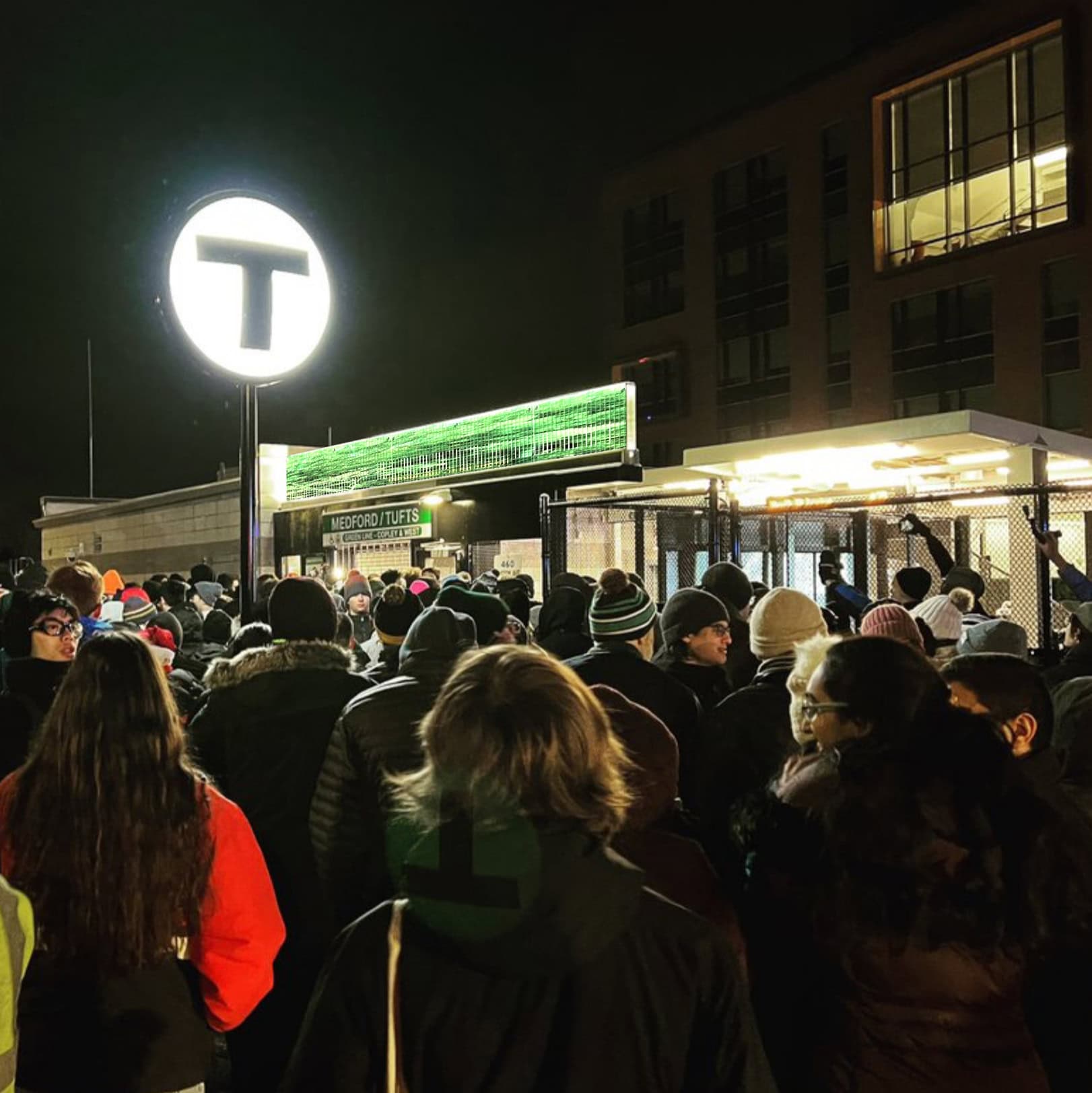 excited students and commuters waiting for the first train at 4 am on opening day